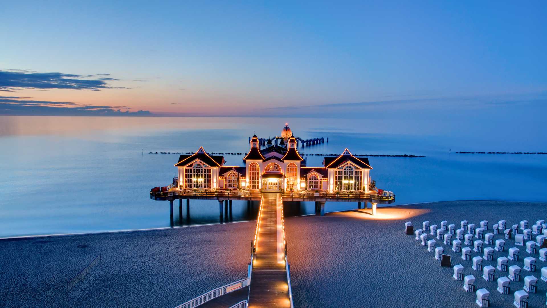 Illuminated Sellin Pier at dusk, Baltic Sea, Germany.