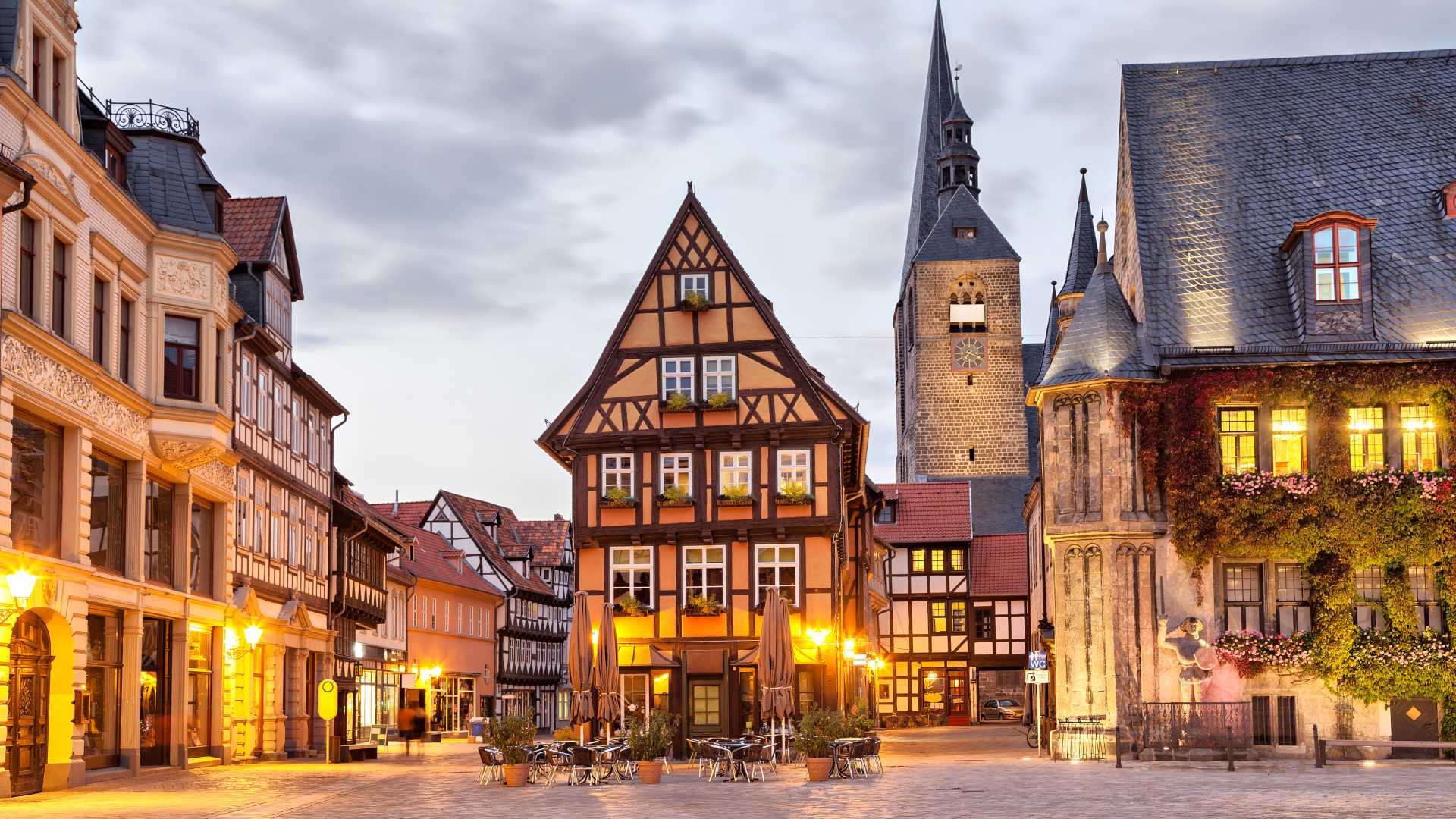 Half-timbered house warmly lit on Quedlinburg's Market Square at dusk, Saxony-Anhalt, Germany.