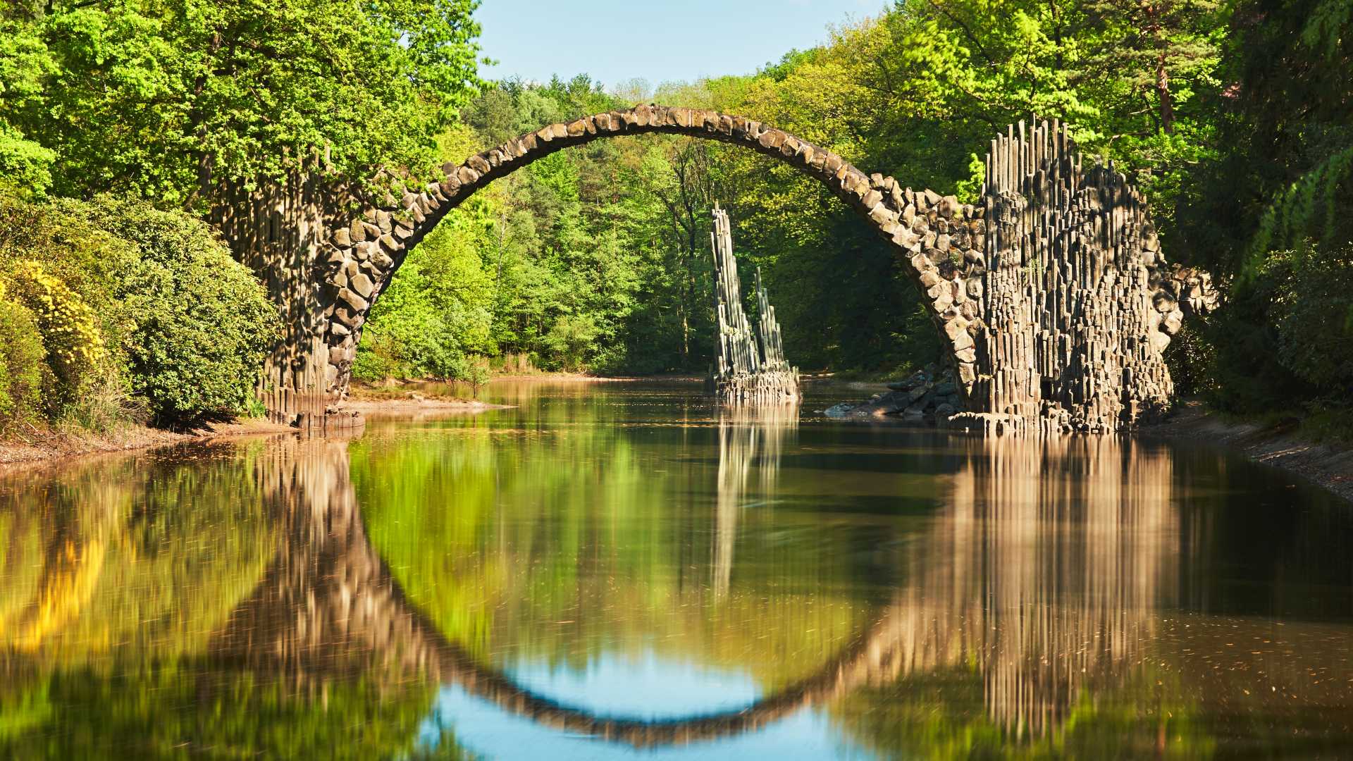 Rakotzbrücke, also known as Devil's Bridge, forms a perfect circle with its reflection in Germany.