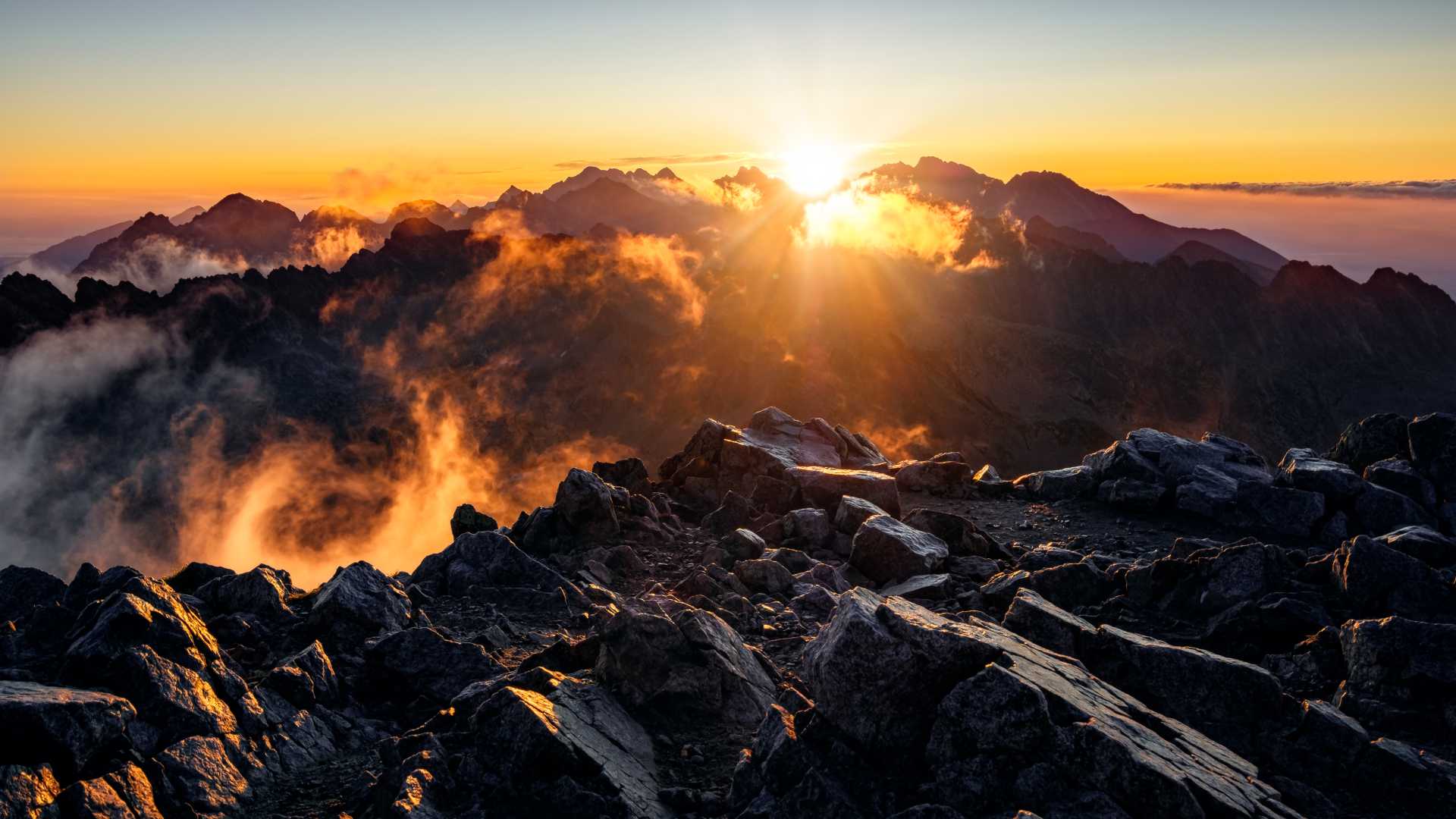 A breathtaking sunrise over the rocky peaks of the High Tatras in Slovakia.