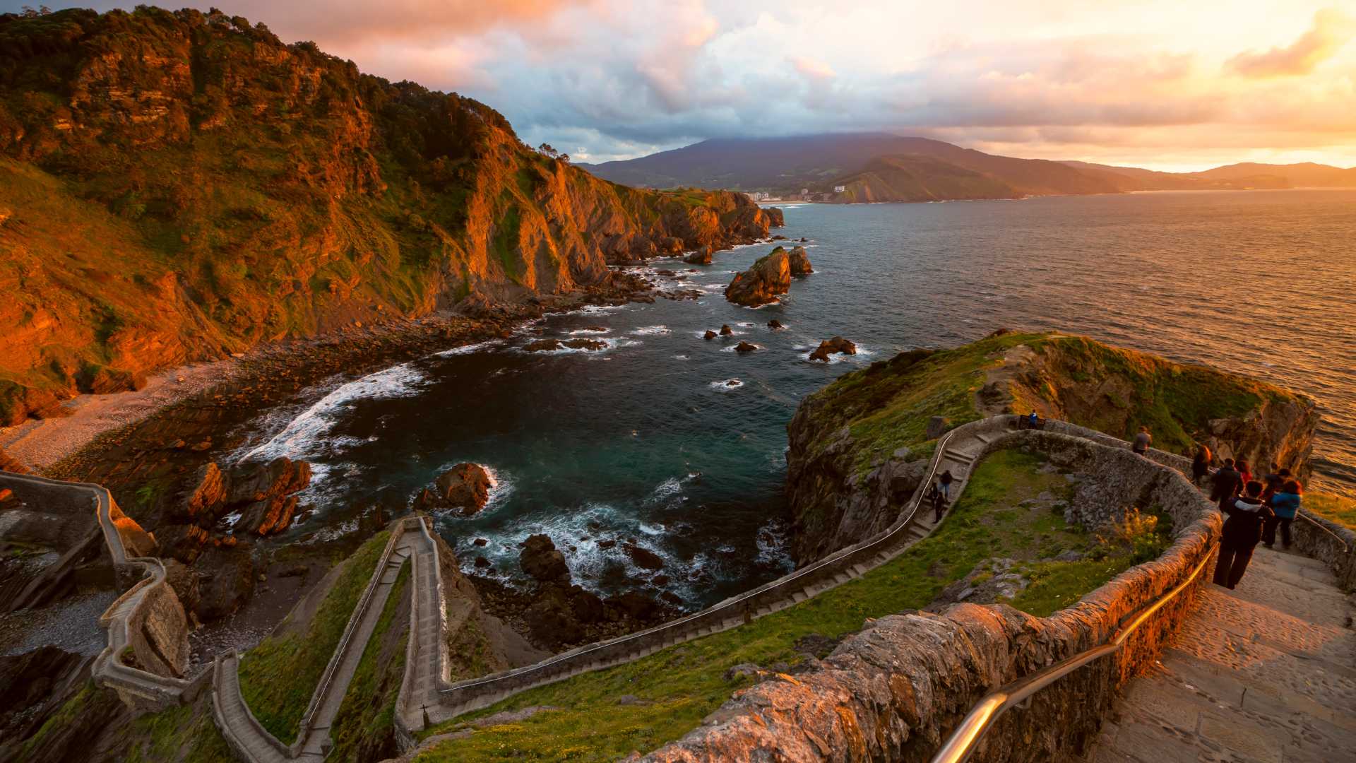 Een zonsondergang over het iconische eilandje Gaztelugatxe met zijn kronkelende stenen pad en hermitage in Baskenland, Spanje.
